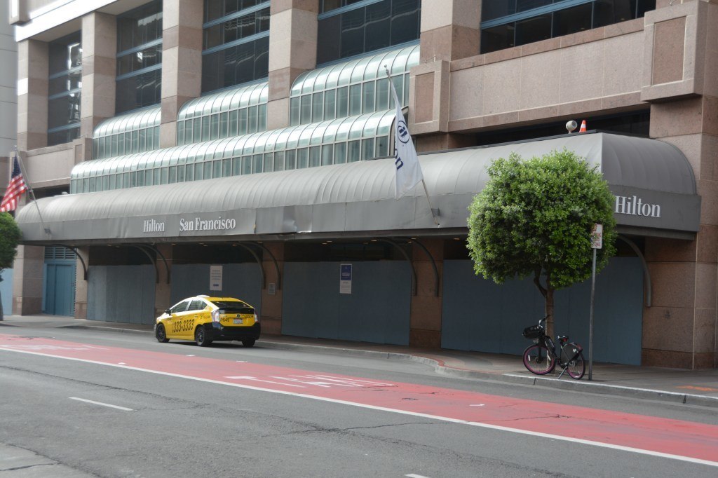 A city street in front of a buildingDescription automatically generated