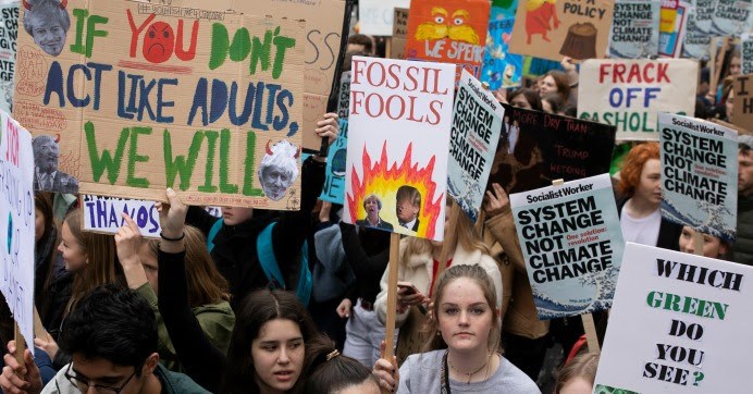 A group of people holding signsDescription automatically generated