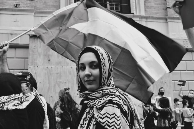 Image of woman with Palestinian flag.
