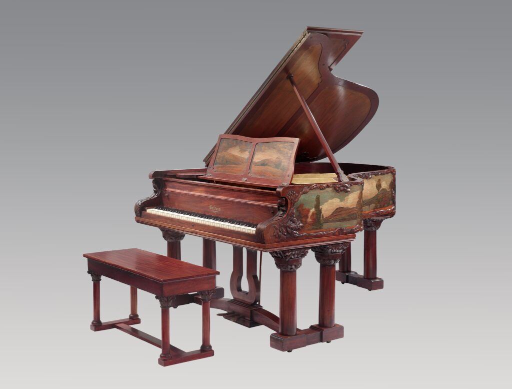 A piano with a bench Description automatically generated