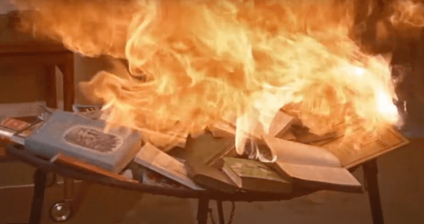 A pile of books on fire Description automatically generated