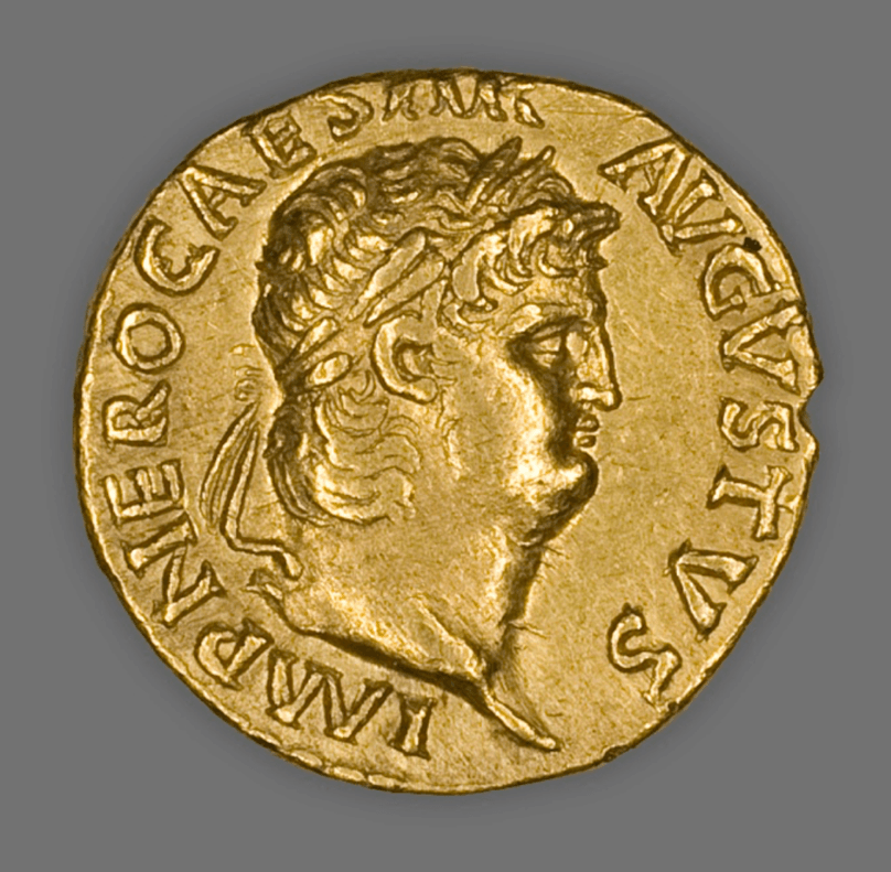 A gold coin with a face on it Description automatically generated