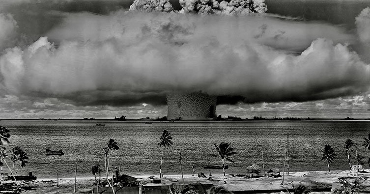 A large mushroom cloud over water AI-generated content may be incorrect.