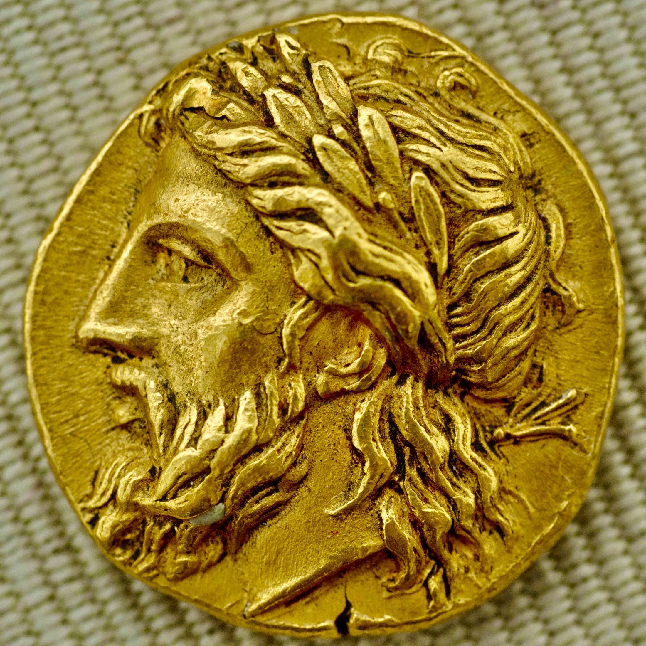 A gold coin with a person's faceAI-generated content may be incorrect.