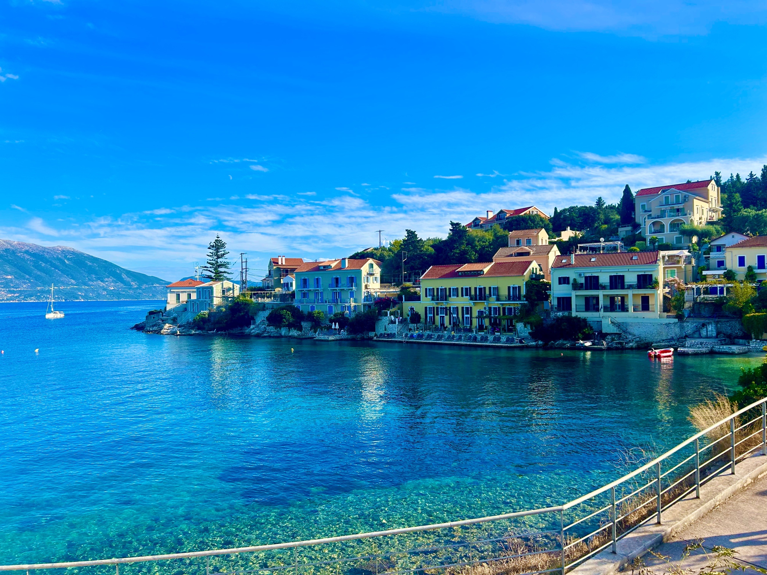 A body of water with buildings and a mountain in the background AI-generated content may be incorrect.