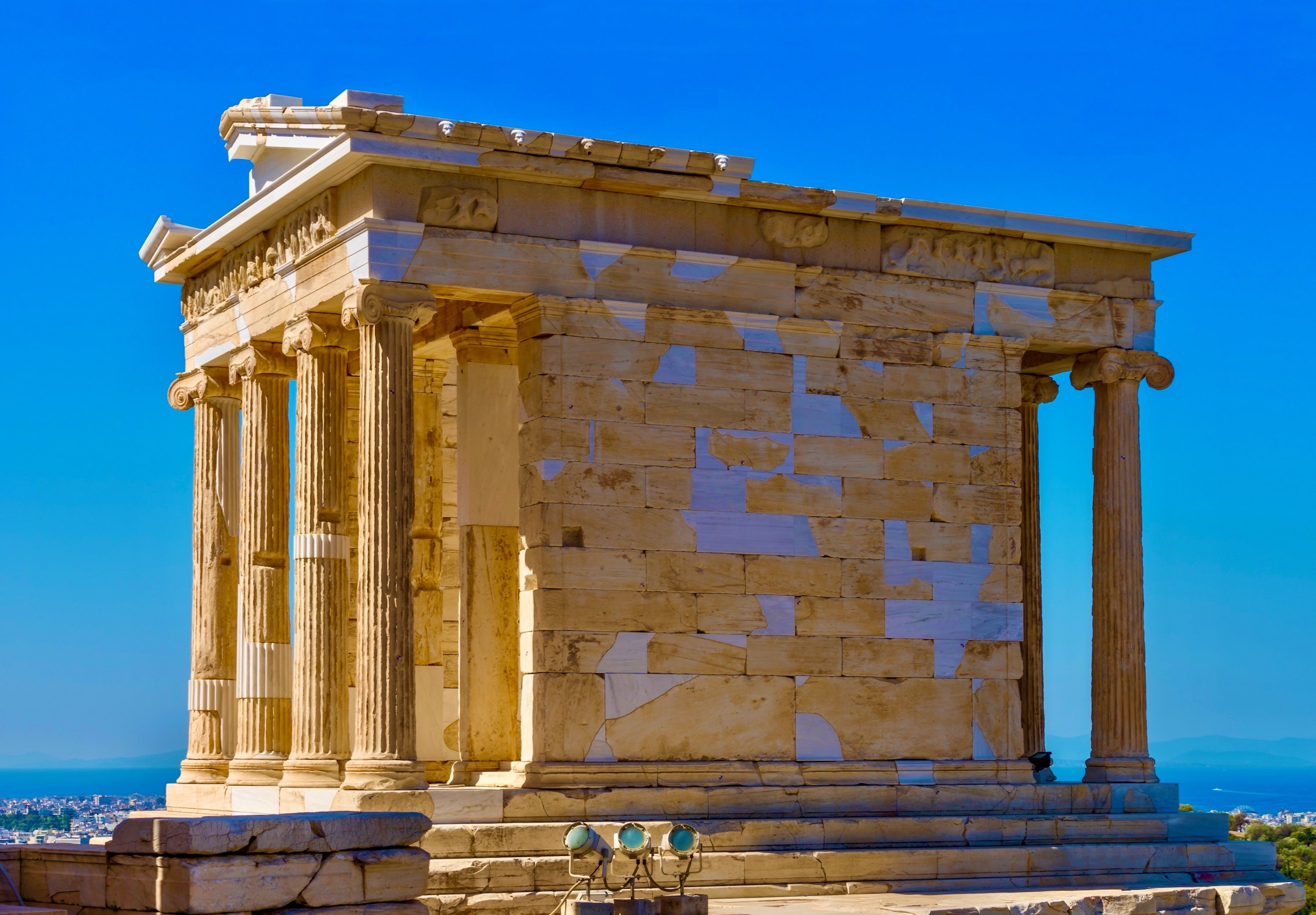 A stone building with columns AI-generated content may be incorrect.