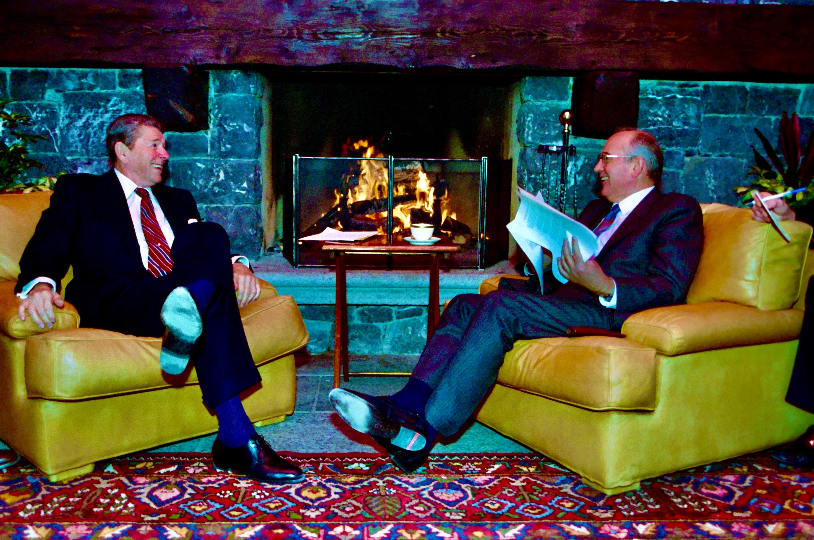 A pair of men sitting in chairs AI-generated content may be incorrect.