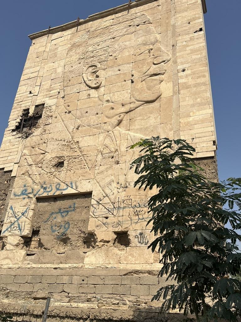 A stone building with a face carved on itAI-generated content may be incorrect.