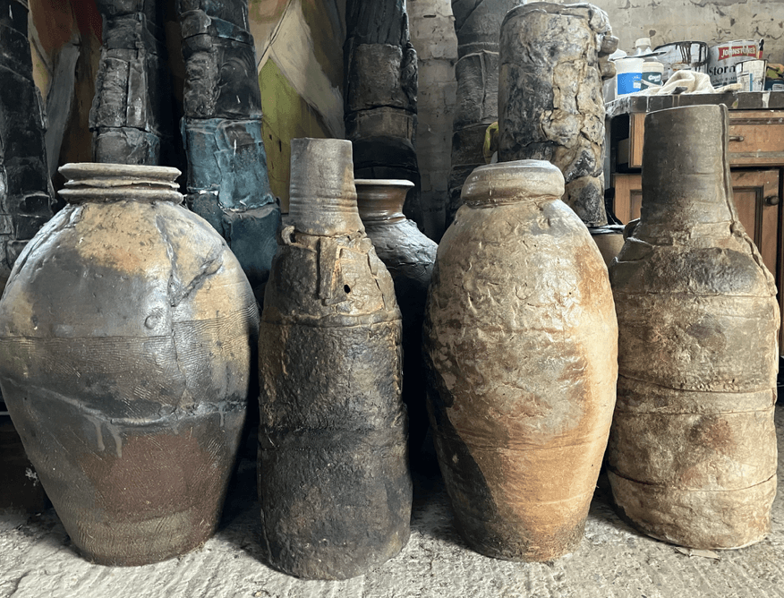 A group of large clay pots AI-generated content may be incorrect.