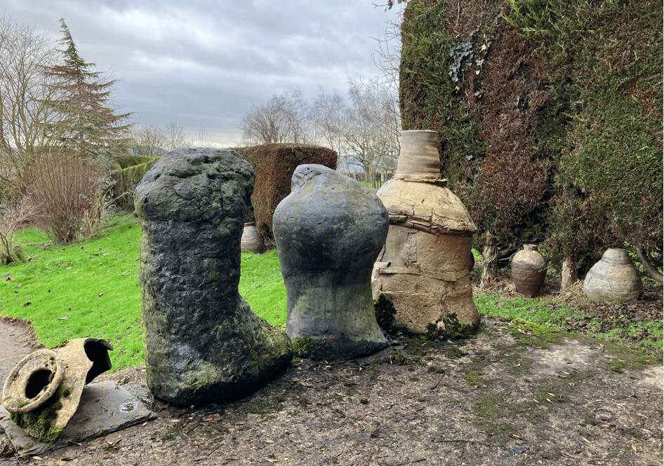 A group of stone sculptures in a garden AI-generated content may be incorrect.