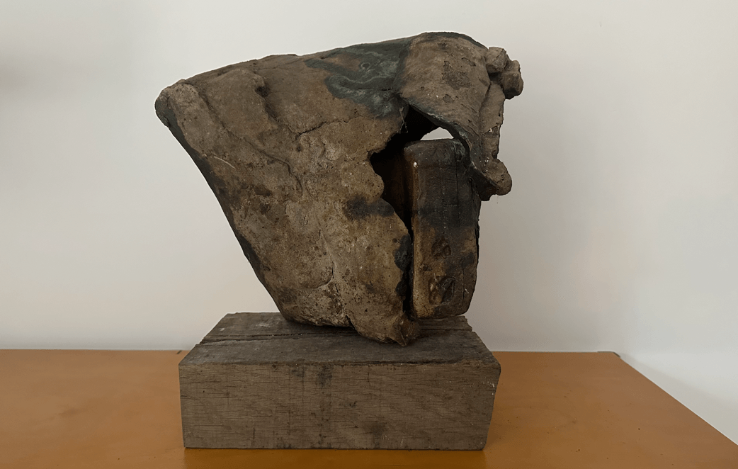 A rock on a wood block AI-generated content may be incorrect.