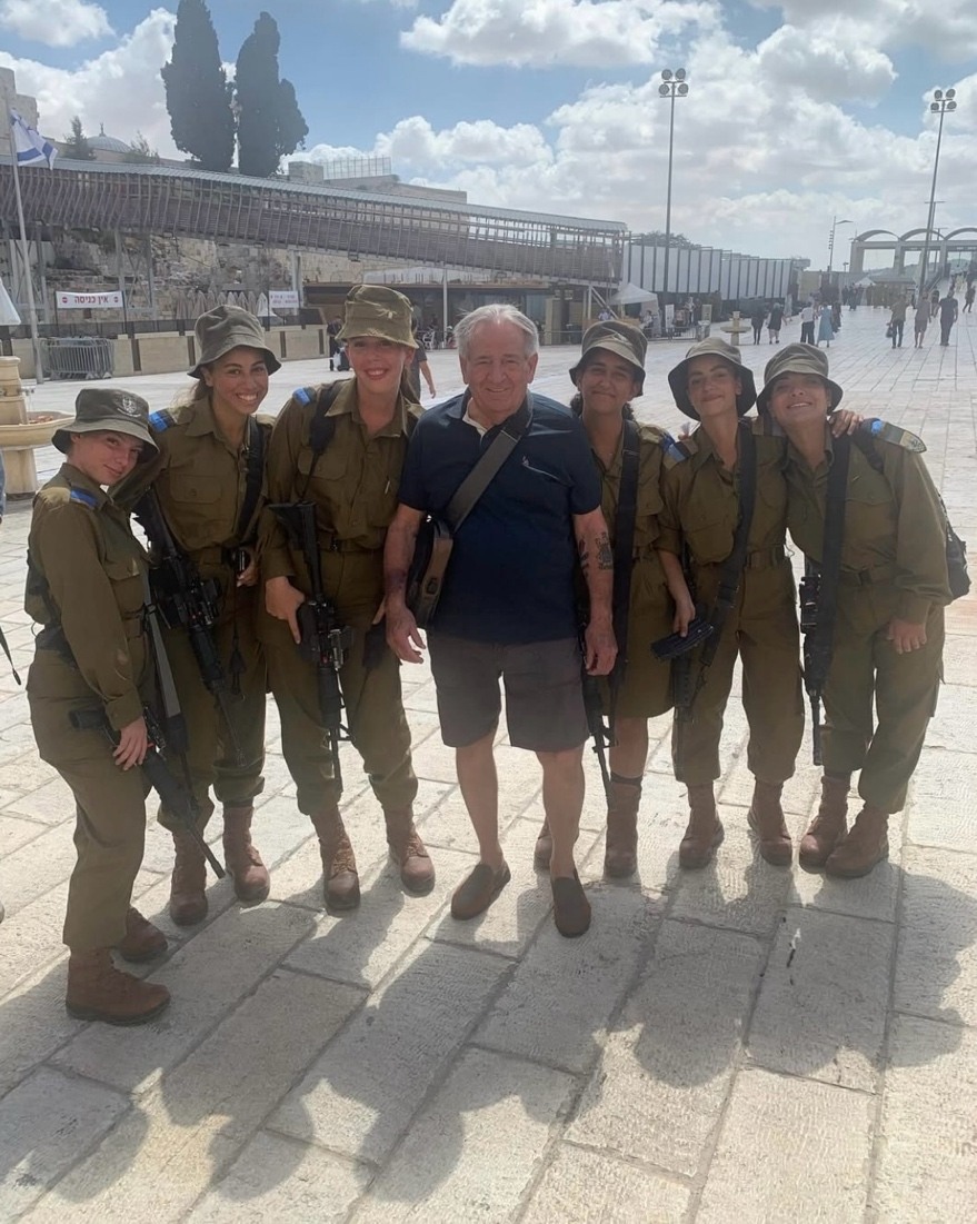 A group of people posing for a photo AI-generated content may be incorrect.